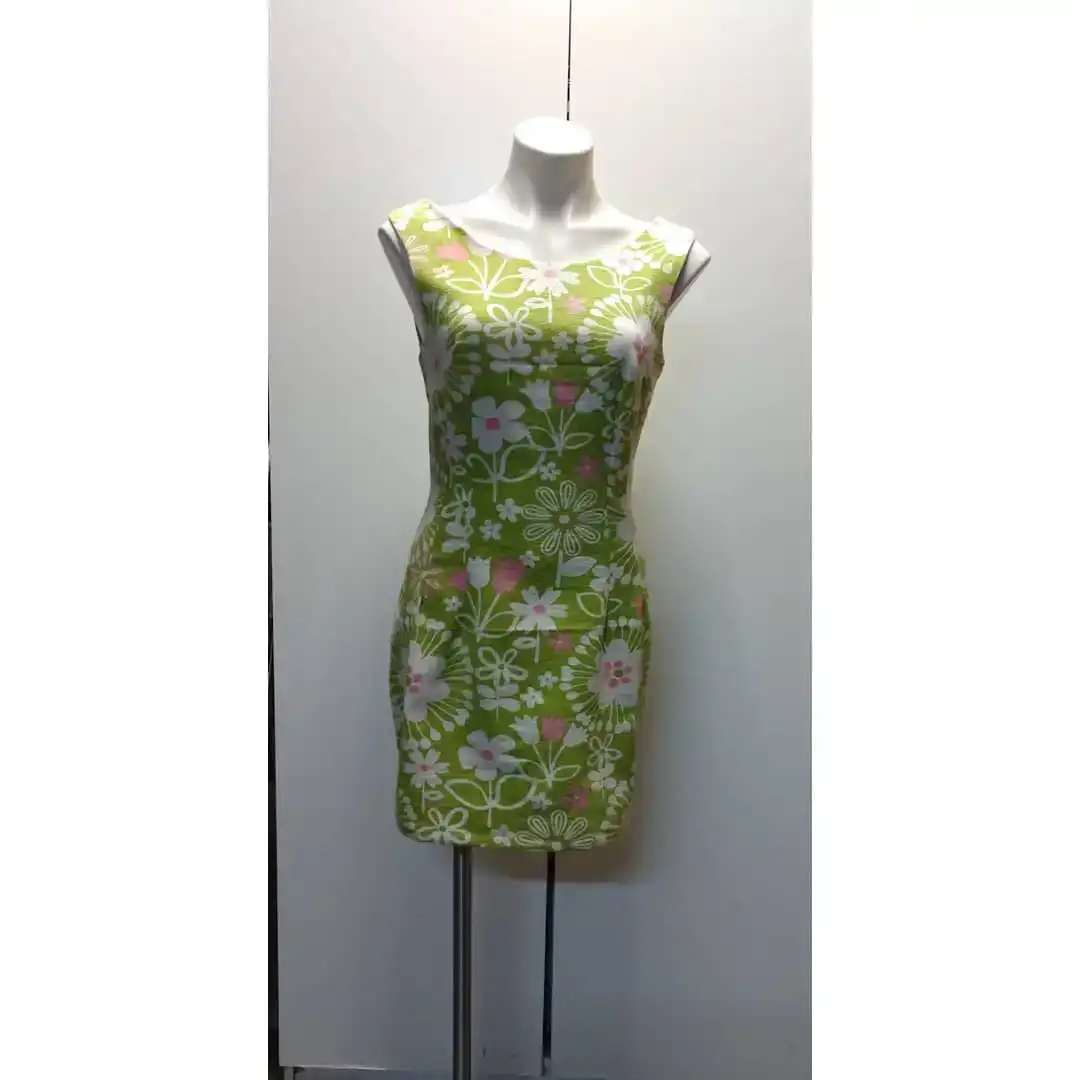 Front view of a sleeveless green floral sheath dress on a mannequin.