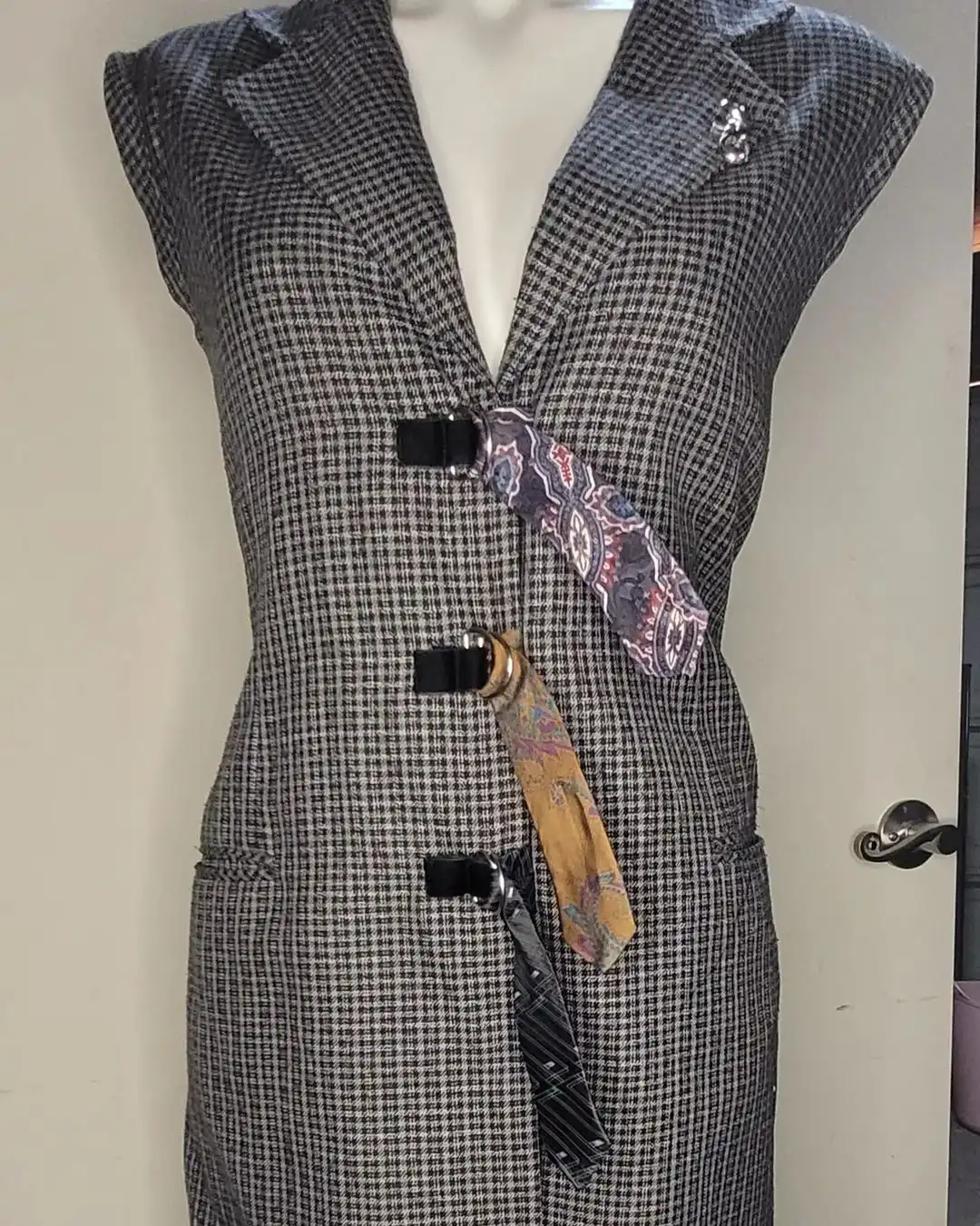 front of plaid dress that is cinched with 3 different ties through metal loops